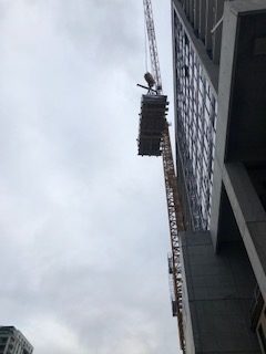 stainless steel pool being lifted to rooftop